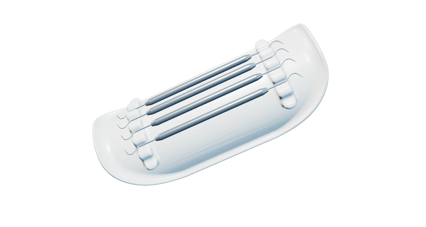 ErgoTray and four dental instruments under a studio spotlight.